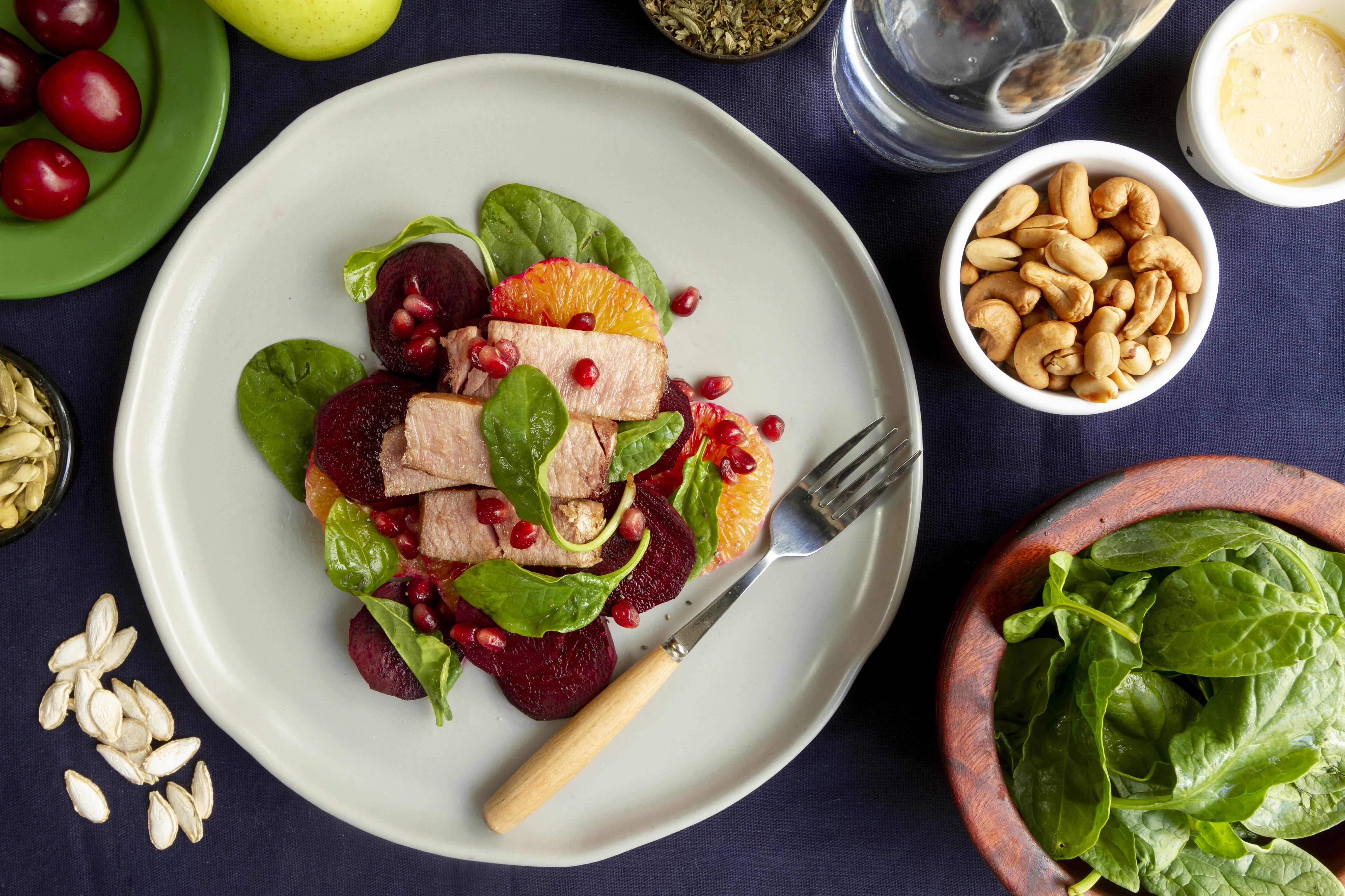 Top view of flexitarian food surrounded by nuts and vegetables